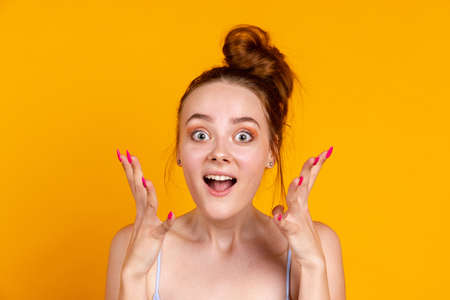 Portrait of beautiful girl isolated on yellow studio background. Female fashion model in casual clothes. Concept of human emotions, facial expression, natural beauty, youthの写真素材