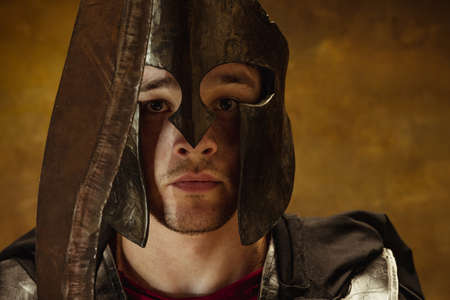 Close up of face of medieval person, brutal man, warrior or knight in helmet isolated on vintage...