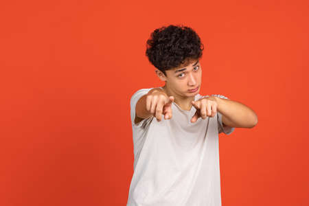 Asian mans portrait isolated over red studio background with copyspace for ad. Concept of human emotions, fashion, beauty, youthの写真素材