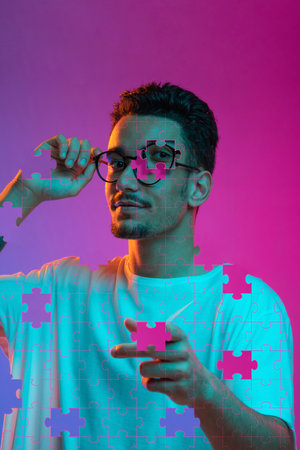 Artwork. Portrait of young man made of missing pieces of puzzle, modern art collage. Concept of...