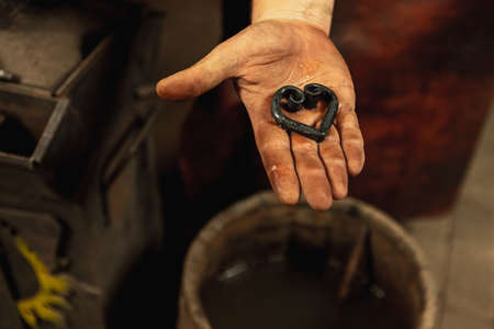 Close-up blacksmith equipment. Hammer, metal and anvil. Concept of labor, retro professions, vintage,adの写真素材