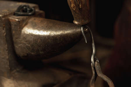 Close-up blacksmith equipment. Hammer, metal and anvil. Concept of labor, retro professions,...