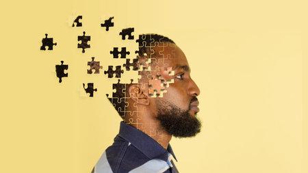 Artwork. Side view of young mans head made of flying pieces of puzzle, modern art collage. Concept...
