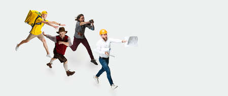 Hurry up. Group of mixed-age men with different professions running isolated on white studio...