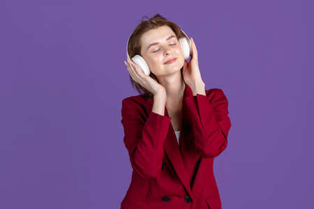 Half-length portrait of young girl isolated on purple, lilac color studio background. Concept of human emotions, facial expression, cosmetics, youthの写真素材