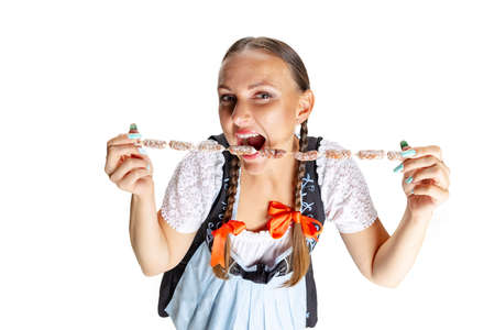 High angle view of sexy Oktoberfest woman, waitress wearing a traditional Bavarian or german dirndl isolated on white studio background.の写真素材