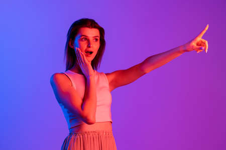 Studio shot of young Caucasian girl isolated on purple, lilac color studio background. Concept of human emotions, facial expression, cosmetics, youthの写真素材