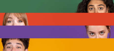 Collage of close-up male and female eyes isolated on colored backgorund with copy space for ads. Multicolored stripes. Concept of equalityの写真素材