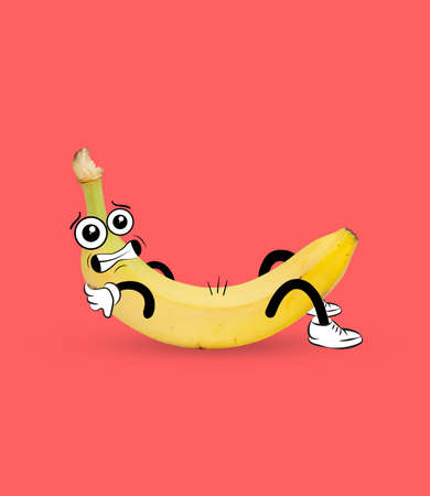 Funny cute yellow banana, dude pumps press isolated over coral background. Drawn fruit in a cartoon style. Vitamins, healthy lifestyle.の写真素材