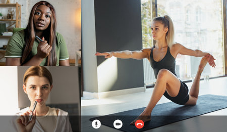 Yoga class online. Young multiethnic women watching online sport trainings, lessons using video app. PC, laptop screen with fitness coachの写真素材