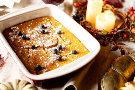 Close-up traditional pumpkin pie. Festive decorated table for celebrating Happy Thanksgiving dayの写真素材