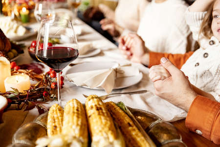 Close-up holiday decorated table for Thanksgiving day with wine and traditional food, dishes.の写真素材
