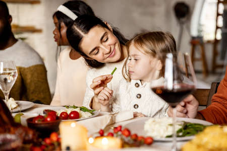 Little cute girl, kid with mother and father celebrate Thanksgiving day at home, indoors. Family, holiday concept.の写真素材