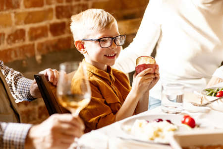 Little cute boy, kid visits grandparents and celebrate Thanksgiving day at home, indoors. Family, holiday concept.の写真素材