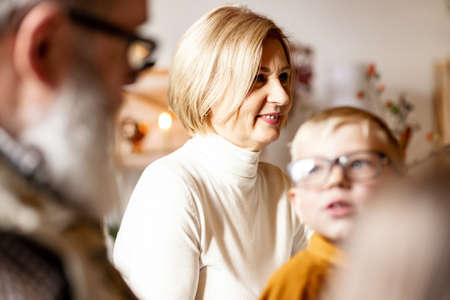 Little cute boy, kid visits grandparents and celebrate Thanksgiving day at home, indoors. Family, holiday concept.の写真素材