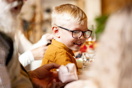 Little cute boy, kid visits grandparents and celebrate Thanksgiving day at home, indoors. Family, holiday concept.の写真素材