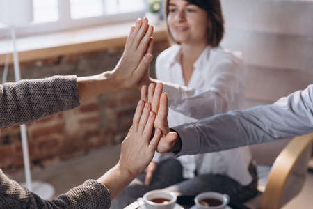 Close-up male and female hands. Happy married couple, young man and woman talking with consultant...