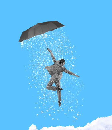Contemporary art collage. Young man, male ballet dancer wearing grey suit flying an umbrella and produces snowの写真素材