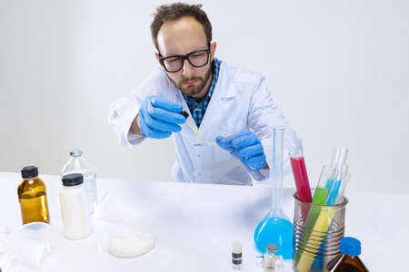 Portrait of young scientist, chemist or doctor conducts chemical research at pharmaceutical lab. Concept of chemistry, medicine.の写真素材