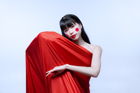 Close-up portrait of young amazing Japanese girl with bright stage make-up isolated on white studio background.の写真素材