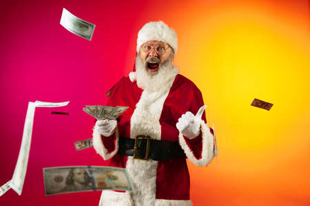 Portrait of emotional Santa Claus wishes wealth and prosperity to every family in New Year 2022. Holidays conceptの写真素材