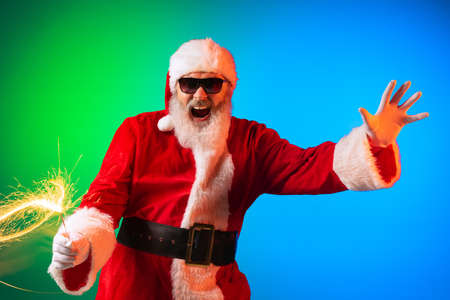 Happy stylish Santa Claus rejoices, has fun, awaits for New Year 2022 and Christmas. Holidays, dreams, joy conceptの写真素材