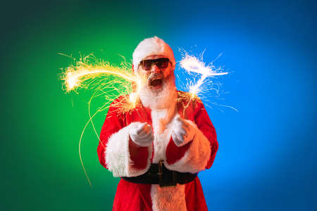 Happy stylish Santa Claus rejoices, has fun, awaits for New Year 2022 and Christmas. Holidays, dreams, joy conceptの写真素材