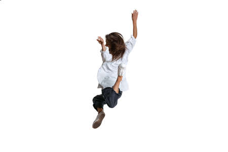 One pretty woman in casual wear jumping, flying isolated on white background. Art, motion, action,...