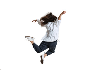 Young woman in casual wear moves dynamically isolated on white background. Art, motion, action,...