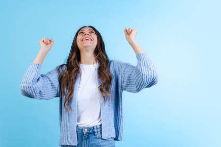 Portrait of young emotional girl posing isolated on navy color studio background in neon light. Emotions, facial expressionの写真素材