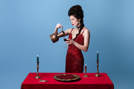Portrait of young beautiful gorgeous woman in dark red, wine color evening dress posing isolated on...