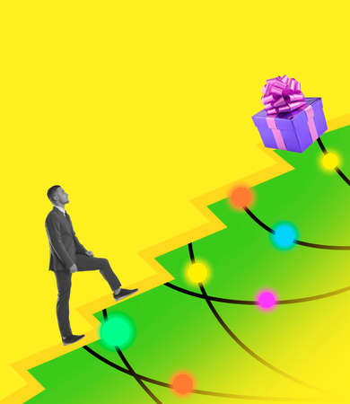 A young man walking along a decorated Christmas tree. Contemporary art collage. Holiday, winter, wishes, New Year and Christmas 2022 concept.の写真素材