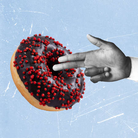 Contemporary art collage of male hand and delicious chocolate donut isolated over blue backgroundの写真素材