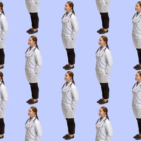 Conceptual seamless pattern made of portraits of female doctor standing isolated on blue background. Concept of health care, medicineの写真素材