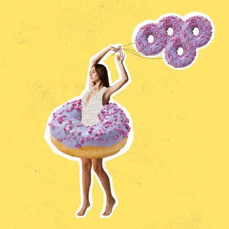 Contemporary art collage of slim woman standing in pink yummy colorful donut isolated over yellow backgroundの写真素材