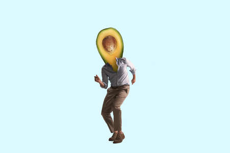 Composition with man headed of avocado isolated on light blue background. Contemporary art collage, modern design.の写真素材