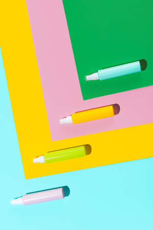 Top view. Set of colored spray bottles for cosmetics, cream, lotion without logos isolated over colored background.の写真素材