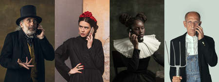 Beautiful women and man as medieval persons or characters from famous artworks in vintage clothing using phone isolated on colored background.の写真素材