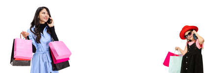 Two persons, young woman and little girl with lots of bags, colorful bright packages isolated over white studio background. Collageの写真素材