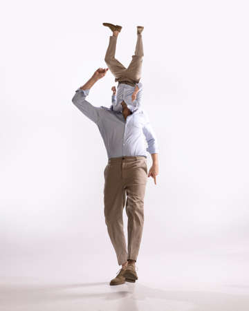 Surreal artwork with portrait of young man, dandy, dude dressed in 50s, 60s style with own body instead head isolated on white backgroundの写真素材