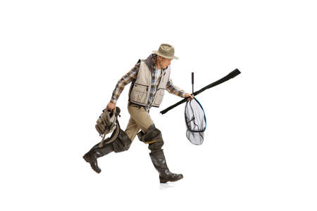 Portrait of young man, professional fisherman with fishing rod, spinning and equipment going to...