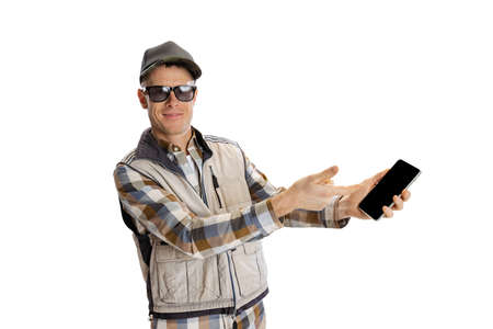 Portrait of young man wearing sport style clothes using phone isolated over white studio background