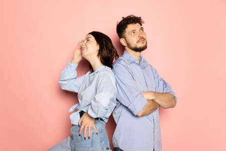 Married couple of young and happy man and woman isolated on pink trendy color background. Human emotions, youth, love and lifestyle conceptの写真素材