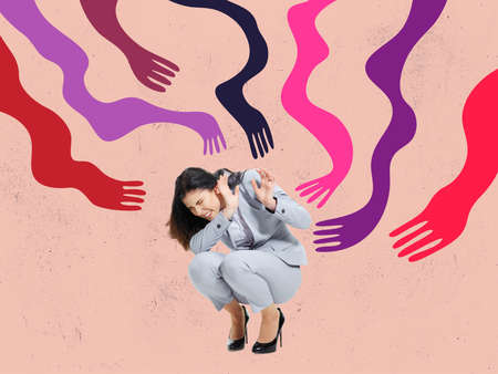 Young scared woman hiding from giant drawn colored creeping arms. Contemporary art collage. Concept of manipulation or addictionの写真素材