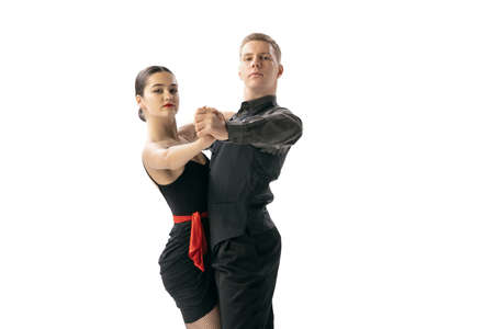 Closeup two young dancers, man and woman dancing Argentine tango isolated on white studio...