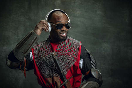 Vintage style portrait of stylish dark skinned man, medieval warrior or knight in sunglasses and...