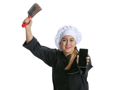 Happy beautiful young woman, lady-cook, chef in black uniform isolated on white background. Cuisine, profession, business, food, taste, restaurant concept.の写真素材