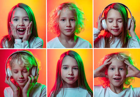 Set of portraits of little cute emotional kids, boy and girl isolated on multicolored studio background in neon light. Education, emotions, facial expression and childhoodの写真素材