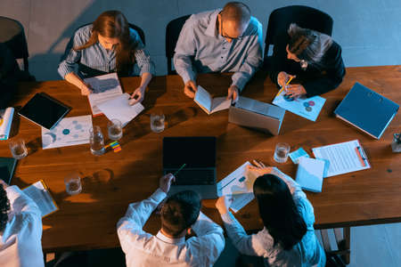 Top view of business conference, meeting. Young colleagues, co-workers, students during work process at office, indoors. Startup, finance, tech and innovation concept.の写真素材