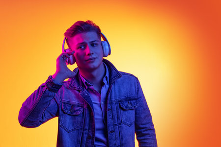 Half-length portrait of young handsome man in casual youth style clothes isolated on orange...